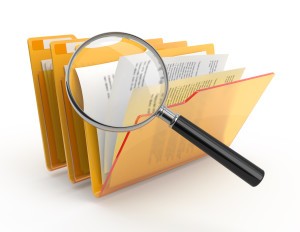 Magnifying glass over the yellow folders. 3d illustration.