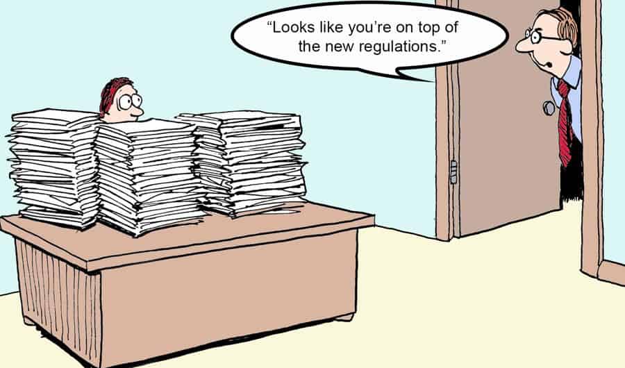 worker at desk piled with papers